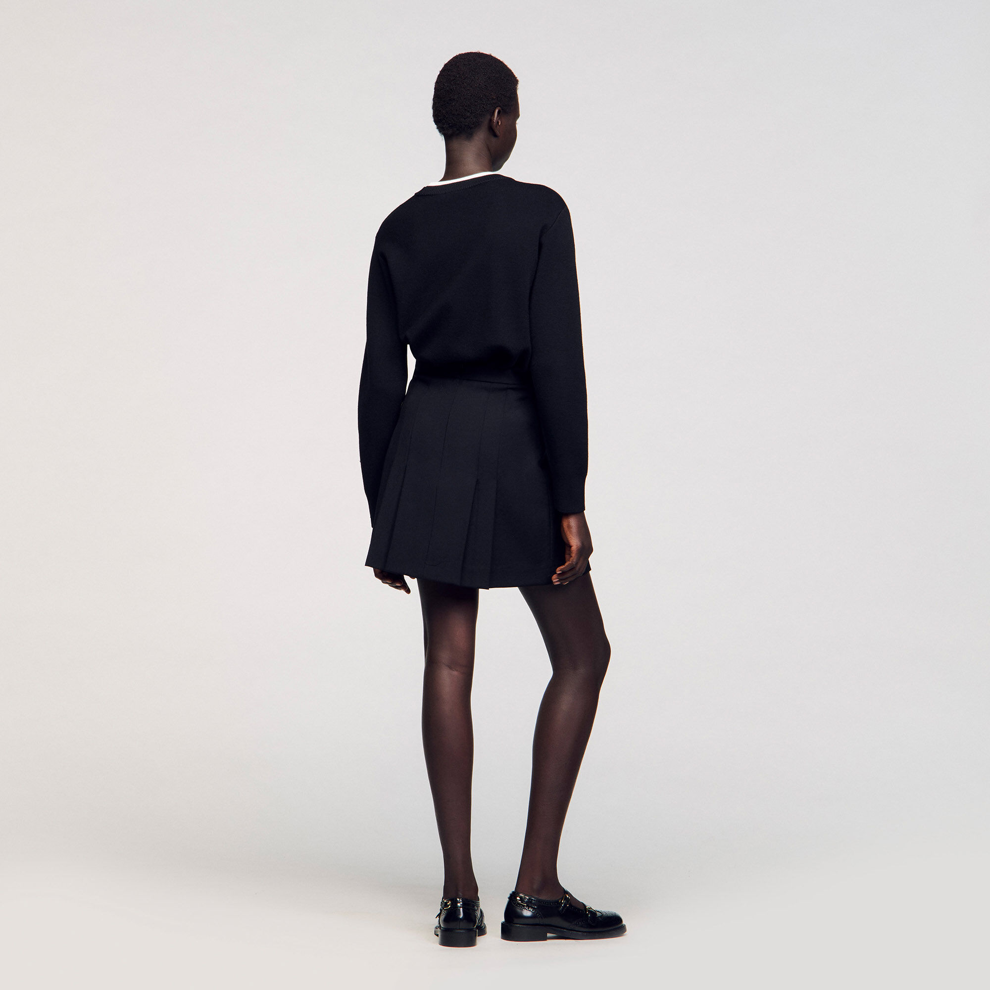 Short skirt with stitched pleats